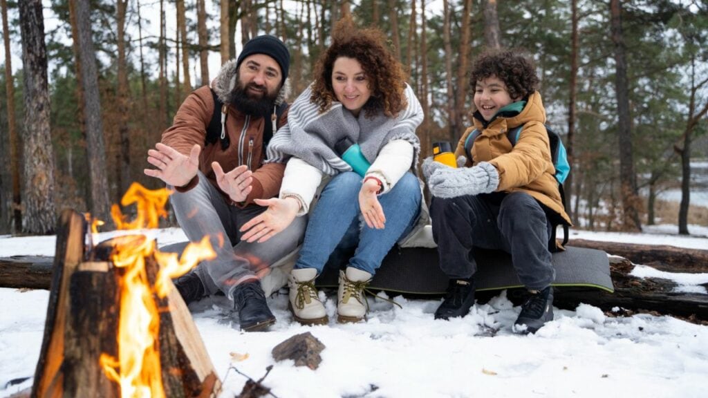 family by winter campfire