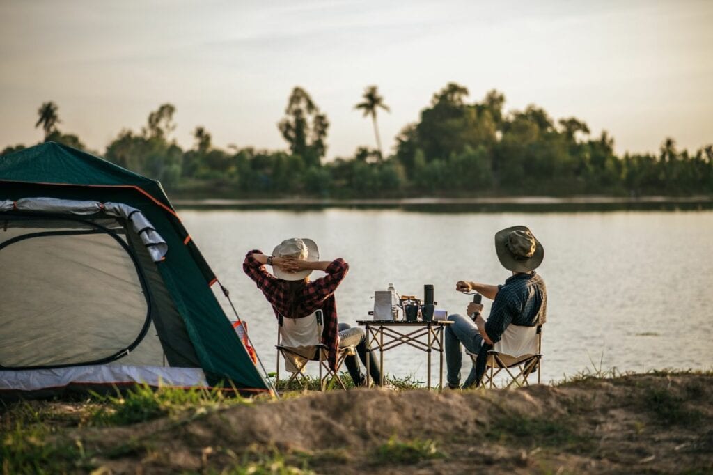 couple camping by lake